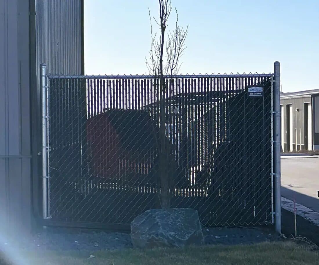 Extraordinaire Fence - Chain Link with Black Slats install in Sioux Falls